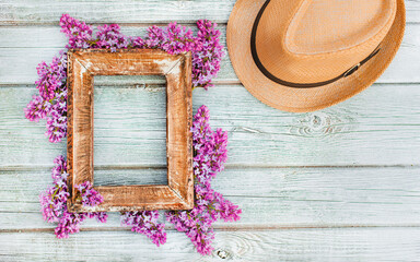 Stylish summer spring composition with vintage photo frame, hat and vintage camera on a white wooden rustic background. Image layout with a copy of the space