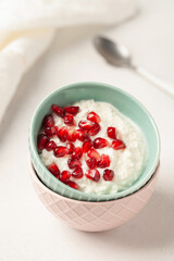 Cottage cheese with pomegranate grains in a bowl on the table. Healthy breakfast