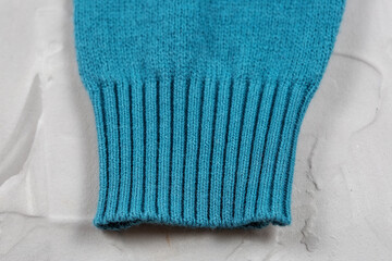 Close-up of knitted elastic blue sweater cuff