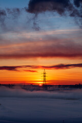 Obraz premium Power line support on the background of the sunset