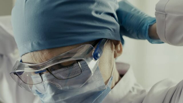 Woman doctor wearing protective suit to fight coronavirus pandemic