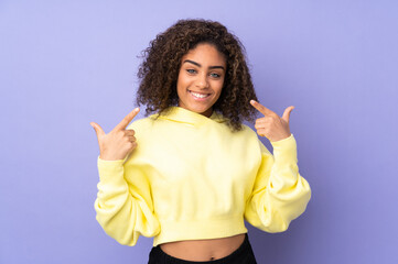 Young African American woman isolated on background giving a thumbs up gesture