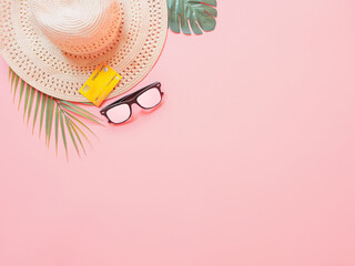 summer accessories concept from credit card and summer collection on pastel red background.