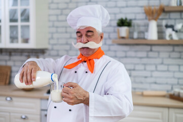 Elderly milkman drinks cow's milk in the kitchen.