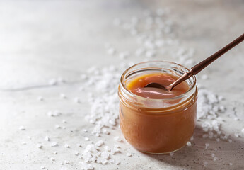 Homemade salted caramel in a glass jar.