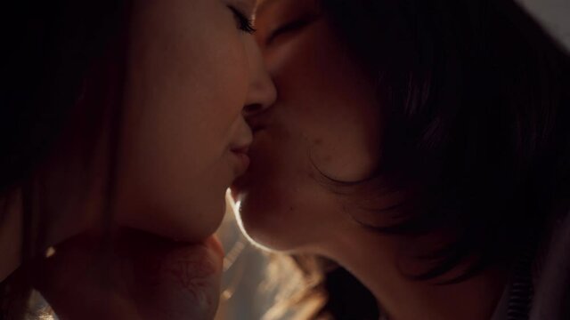 Happy Lesbian Couple Kissing at Home. Two Lovely Girls Spending Time Together, Enjoying Sunny Day. Authentic Tender Moments between Lovely Girlfriends. cinematic Slow Motion Close up Shot