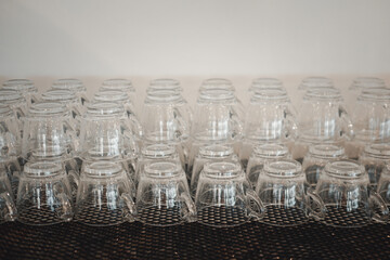 Close up of many empty clean glass cups for coffee or tea in hotel or restaurant