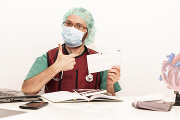 Cardiologist doctor working in his office wearing an operating theatre suit and lead x-ray protective equipment, white background.