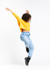 Young African American woman dancing over isolated white background