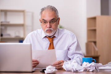 Obraz premium Old male employee in paper recycling concept