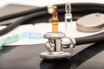still life of a stethoscope with pacemaker battery and medical objects