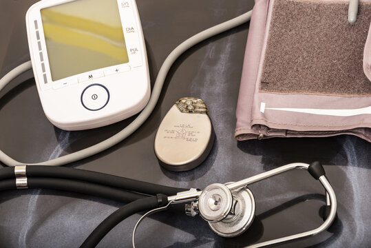 still life of a stethoscope with pacemaker battery and heart pressure measuring device together with medical objects.