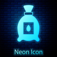 Glowing neon Pack full of seeds of a specific plant icon isolated on brick wall background. Vector