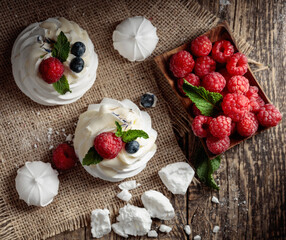 Dessert Pavlova with raspberries, blueberries and mint.