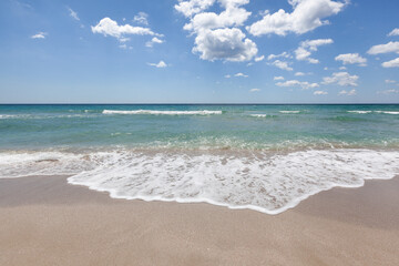 Beautiful beach with foamy sea and bare sky