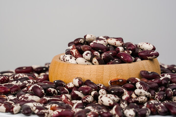 Beans on white background.  Free space for text. Studio shot. Legume family. Red and white beans.
