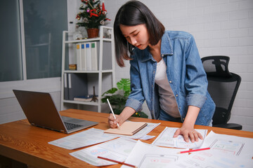 Focused concentrated professional Asian woman standing designer designing UI UX graphical user...