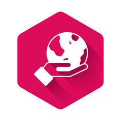 White Human hand holding Earth globe icon isolated with long shadow background. Save earth concept. Pink hexagon button. Vector