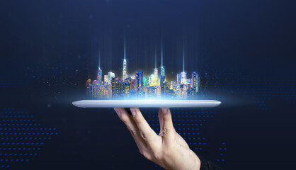 Futuristic city on digital tablet technology concept of businessman hand holding tablet, smart city...