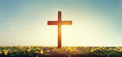 Cross on spring meadow religion and faith