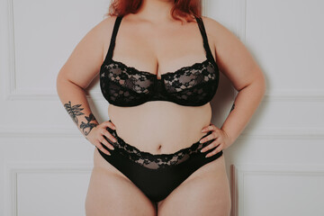 Body acceptance concept.  curvy girl posing in studio against society prejudice