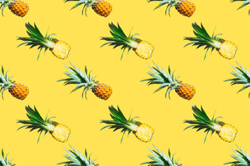 Seamless pattern of ripe pineapples isolated on yellow background. Top view. Exotic tropical fruit summer concept. Pop art