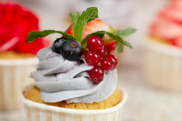 cupcake with cream currant strawberry and blackberry