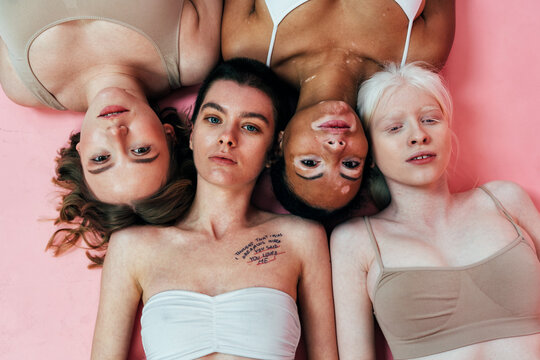 Group of multiethnic women with different kind of skin posing together in studio. Concept about body positivity and self acceptance