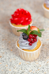 cupcake with cream currant strawberry and blackberry