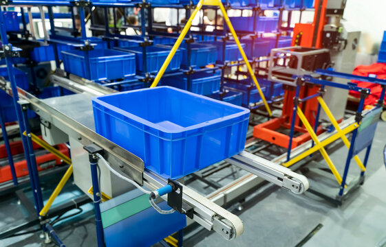 Plastic Boxes In The Cells Of The Automated Warehouse. Metal Construction Warehouse Shelving