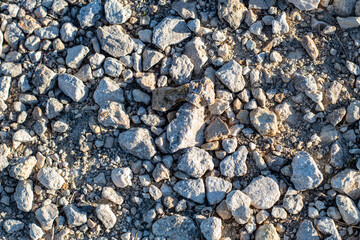 texture of small and big white stones on the lake