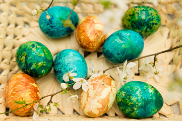 Easter. a Christian religious holiday. speckle chicken eggs in basket. tradition to variegate with various colors and various techniques. biggest spring celebration.