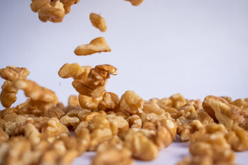 Walnuts falling on white background