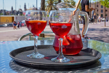 Jug and glasses with sangria beverage on the table in street cafe in center of Barcelona. Spain.