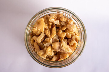 top view of jar with walnuts, isolated on white