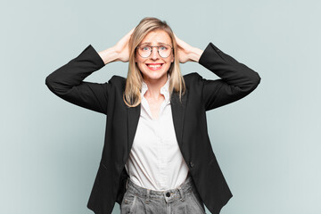 young pretty businesswoman feeling stressed, worried, anxious or scared, with hands on head,...
