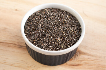 Chia seed in a blue bowl on wood