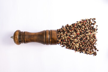 grinder with five peppers seeds isolated on white