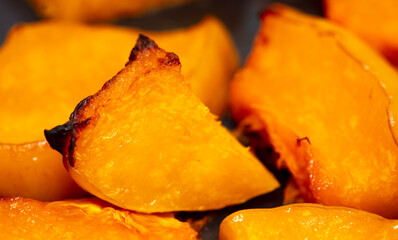 Pieces of pumpkin baked on a baking sheet. Food