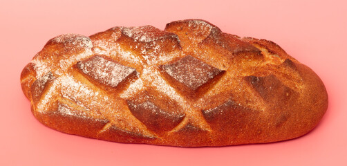 Fresh bread isolated on a pink background.