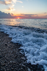 Water by the sea at sunset.