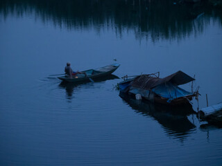 small boats fishing at dusk