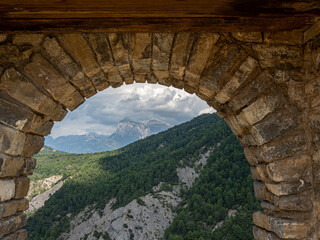 Fototapeta na wymiar stone arch with mountains in the background