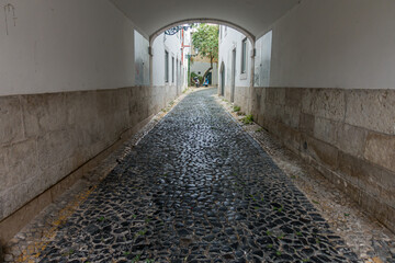 street with cobbled and empty tunnel