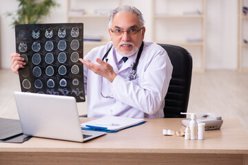 Experienced male doctor radiologist working in the clinic