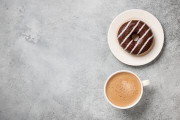 Cup of coffee and chocolate donut