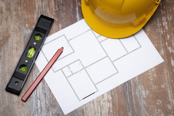 Construction plans with helmet and drawing tools. Architect concept.