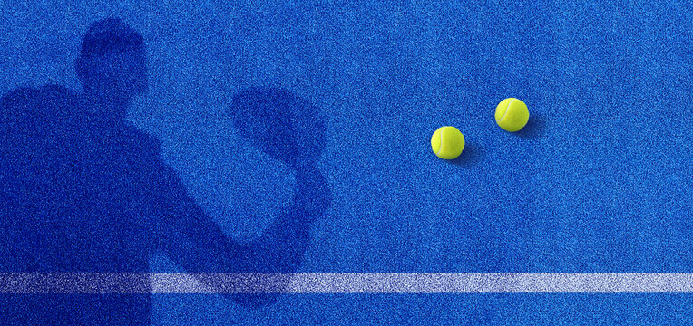 Padel player shadow on a blue playground