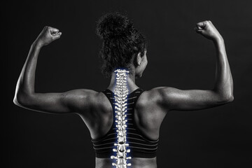 Sporty African-American woman with good posture on dark background, black and white effect - obrazy, fototapety, plakaty