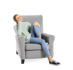Young woman relaxing in armchair on white background
